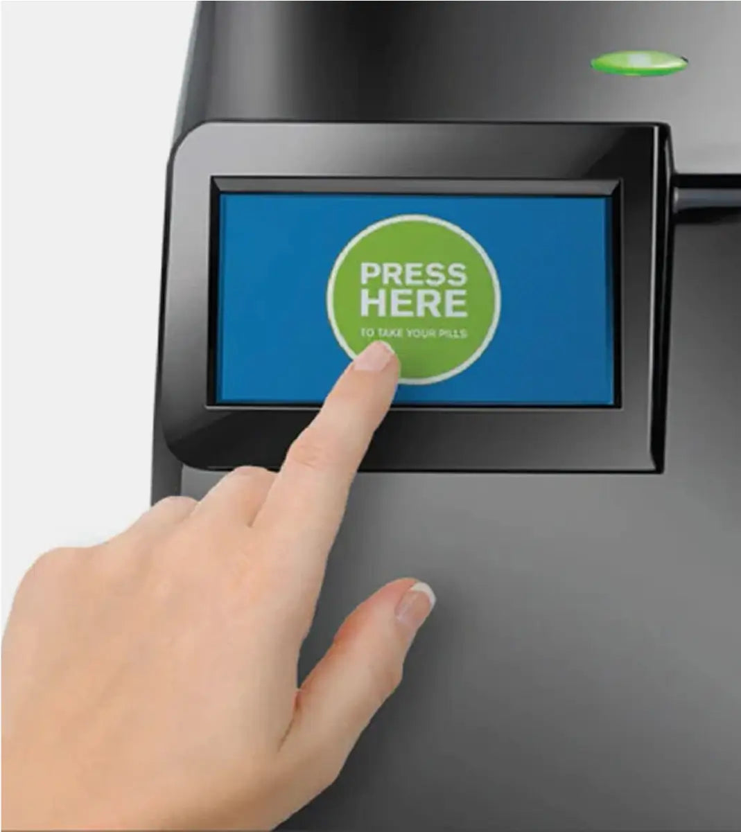 Hand pressing a button on a pill dispenser with a digital display that says Press Here to take your pills